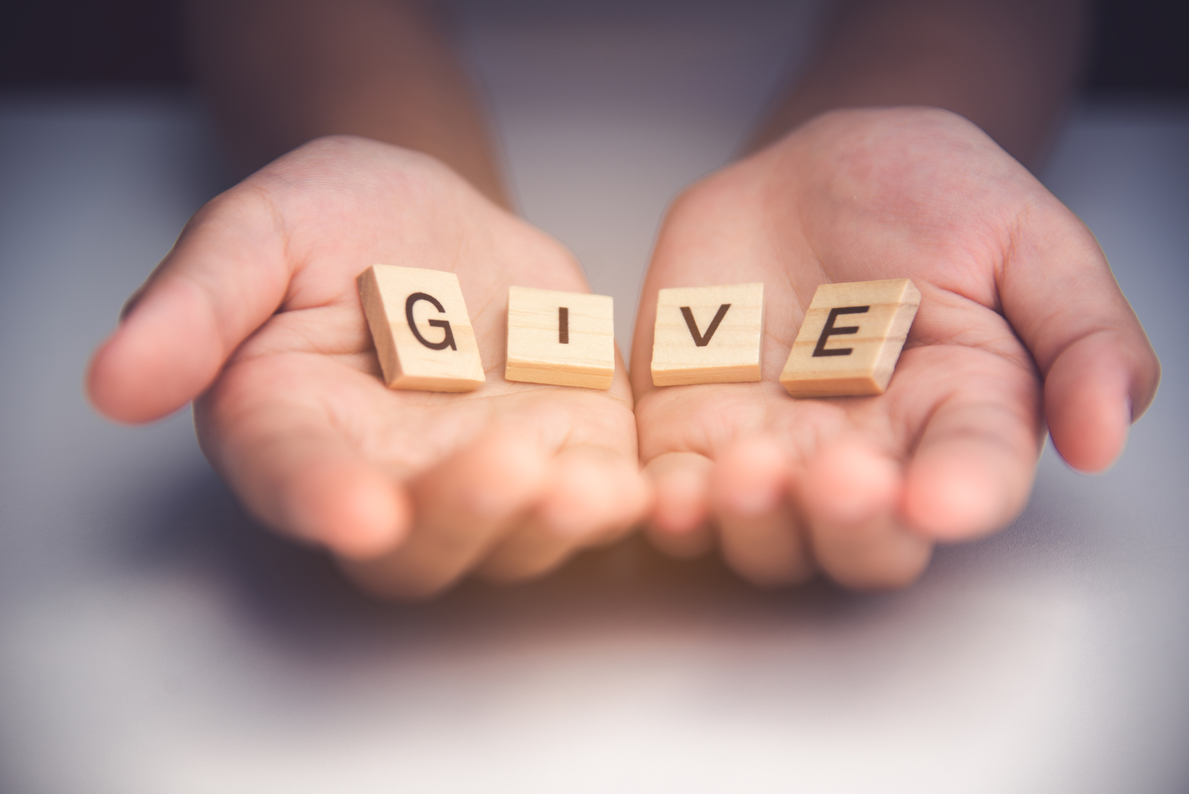 The Word "Give" on a Person's Hand